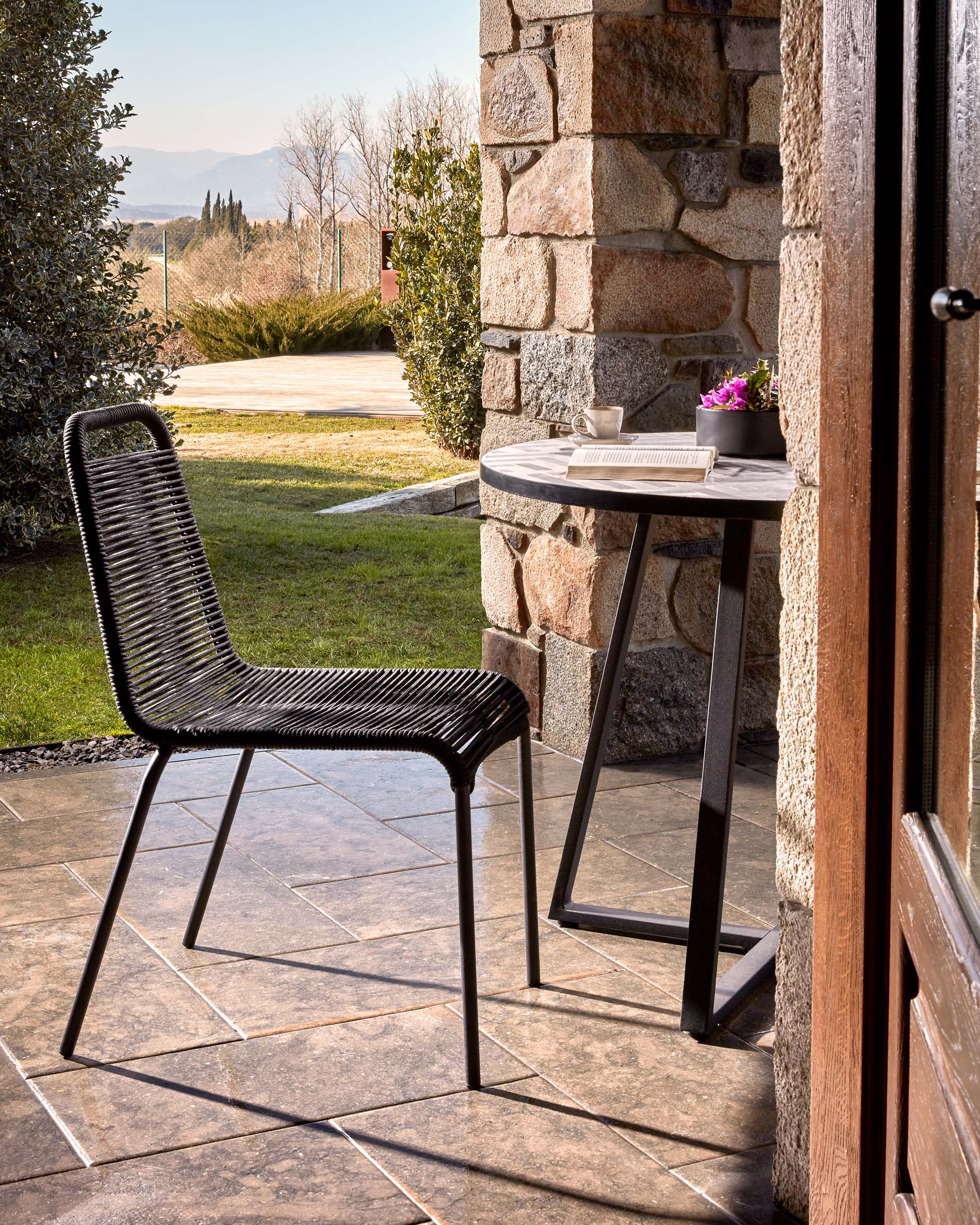 Lambton stackable chair in black rope steel with black finish - Lifestyle