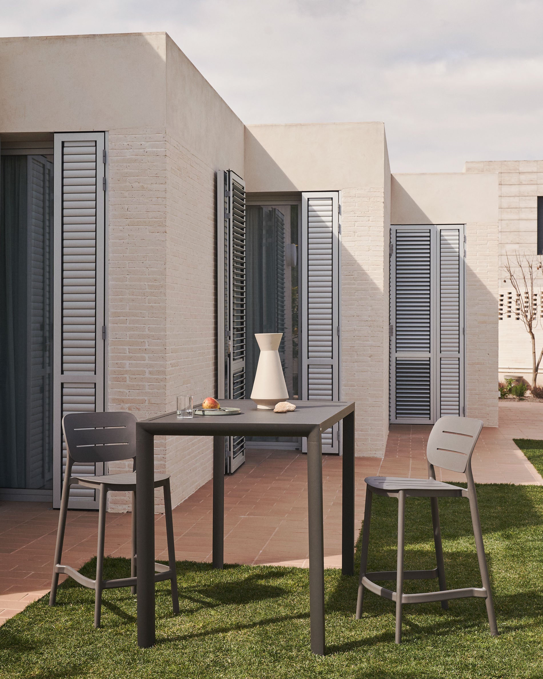 Morella stackable outdoor stool in grey, 65 cm - Lifestyle