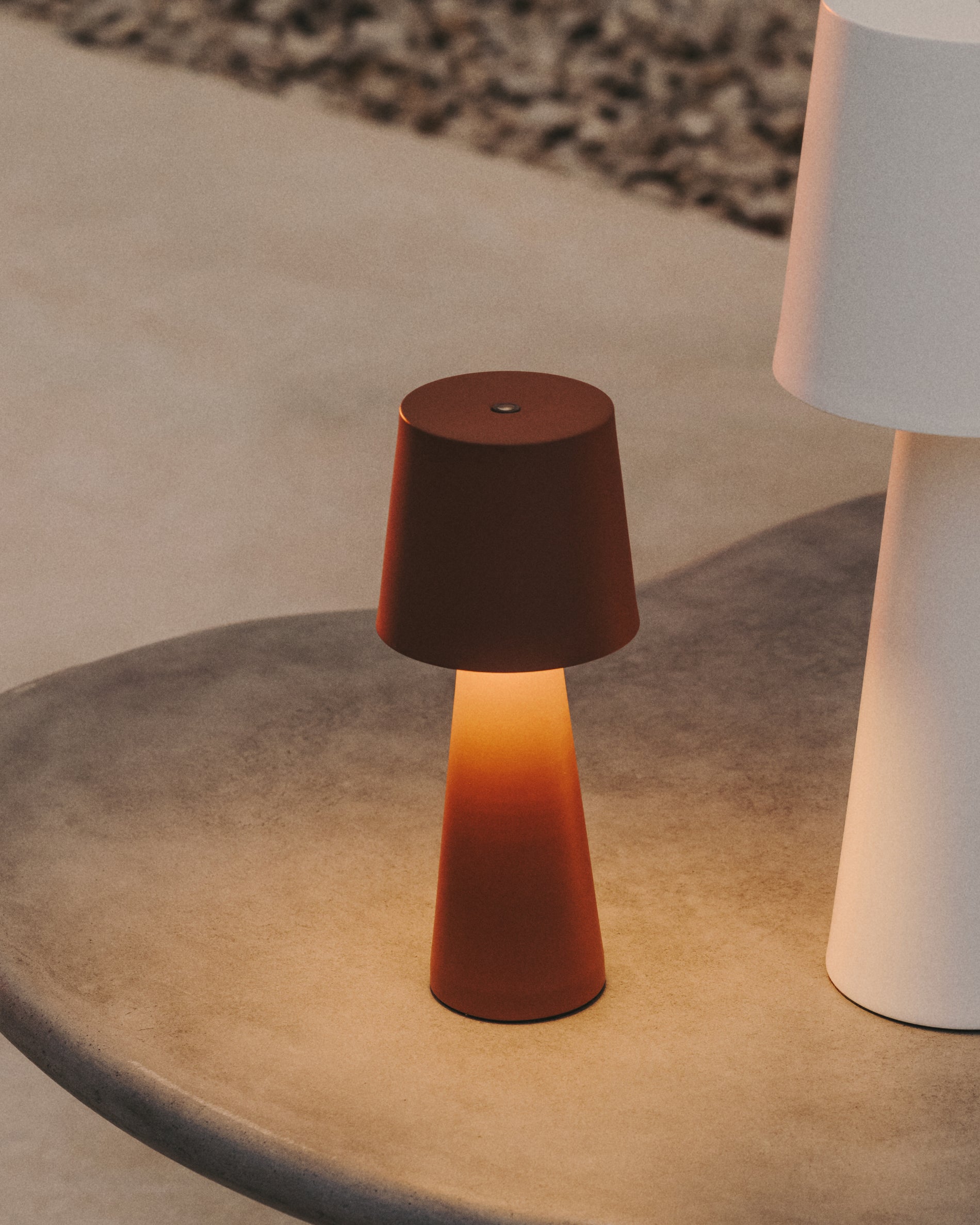 Arenys small outdoor metal table lamp in a terracotta painted finish - Lifestyle