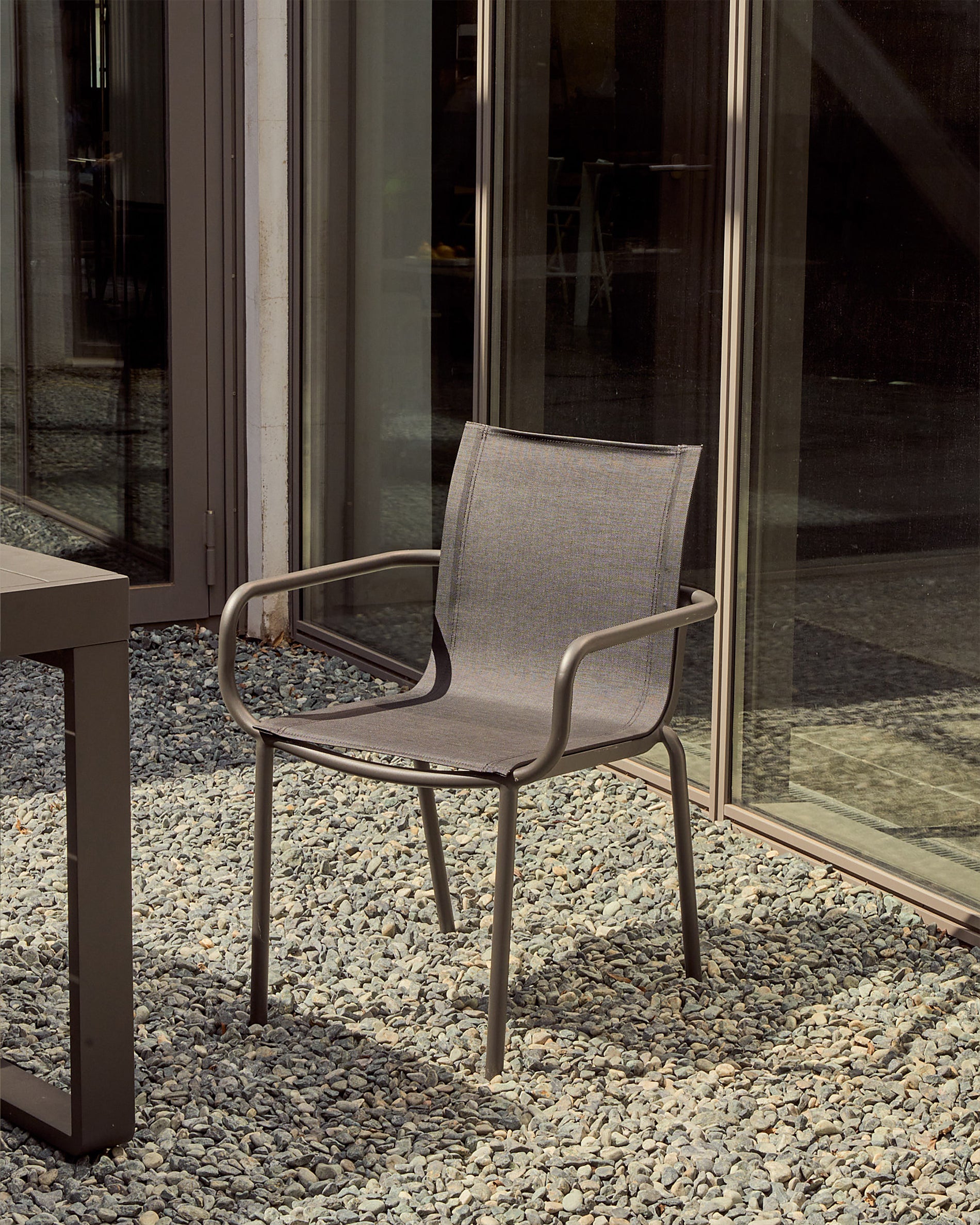 Galdana stackable outdoor chair made of aluminum with a dark grey painted finish - Lifestyle