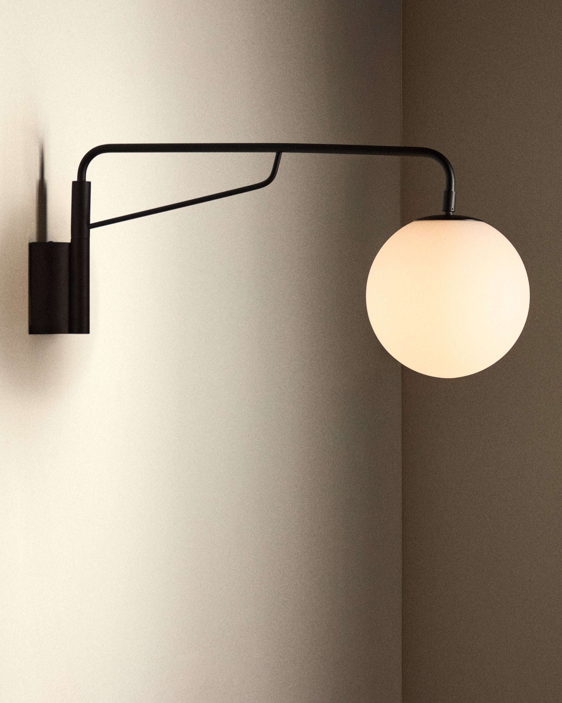 Eilo wall light in black steel with frosted glass globe - Lifestyle