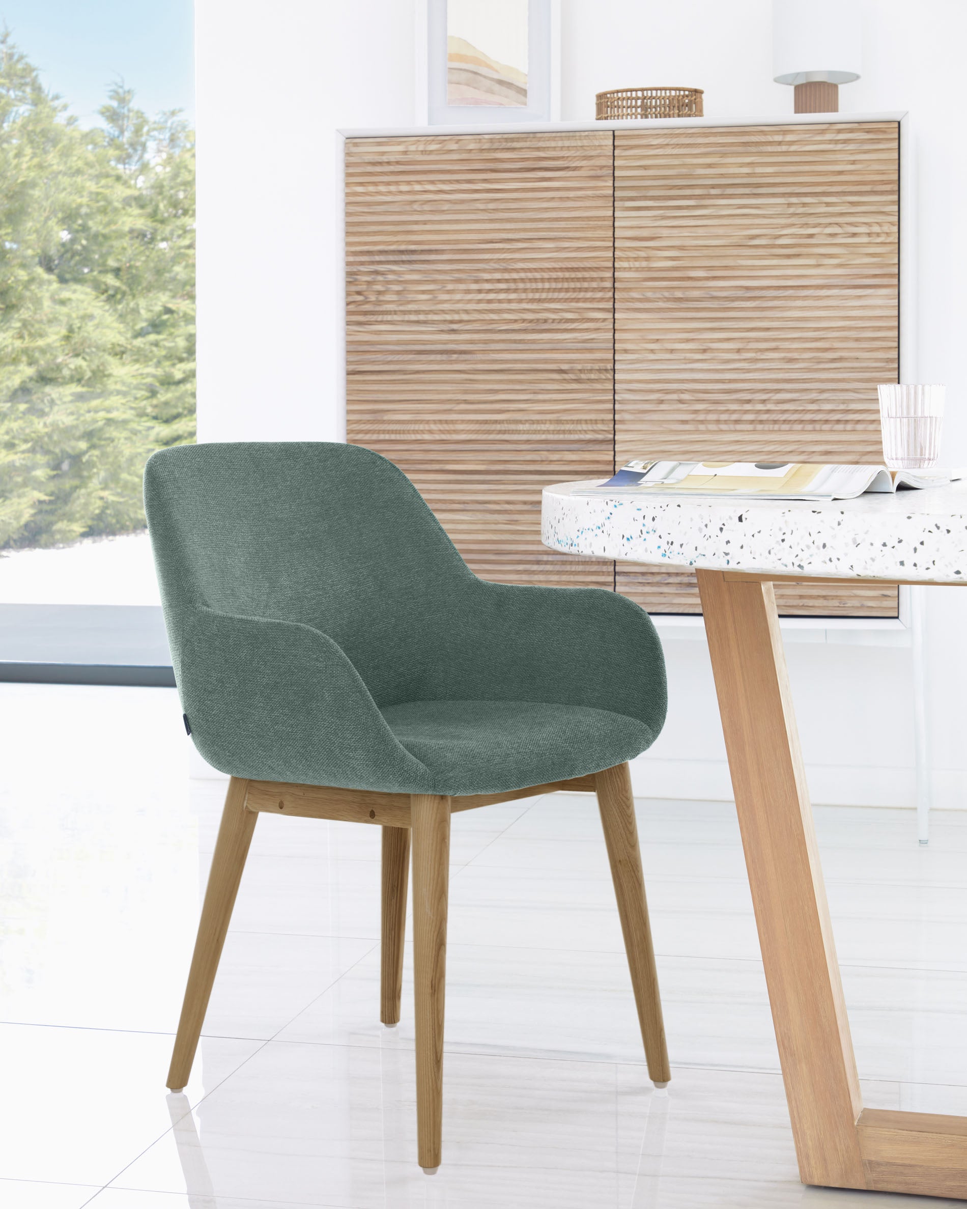 Konna chair in green with solid ash wood legs in a dark finish - Lifestyle