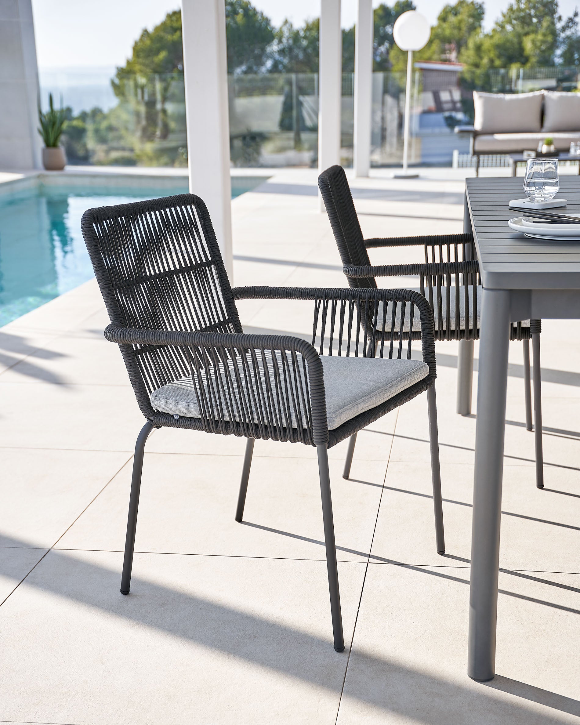 Samanta stackable chair made from black cord and galvanised steel legs. - Lifestyle