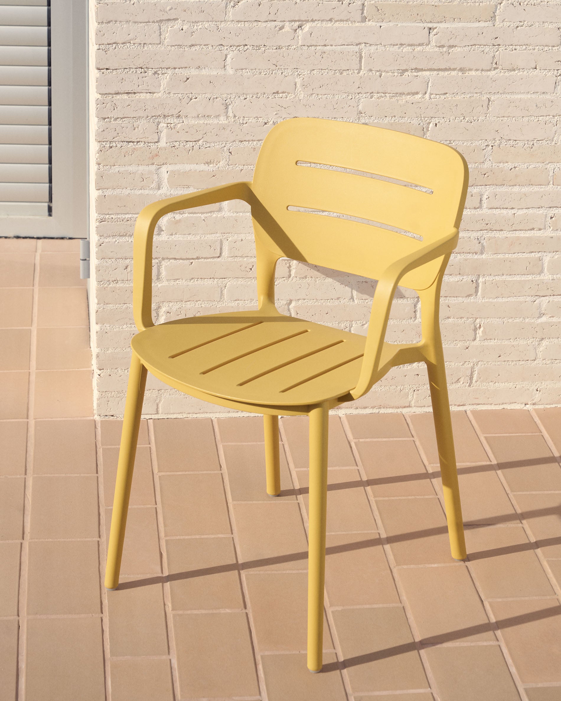 Morella stackable outdoor chair in mustard - Lifestyle