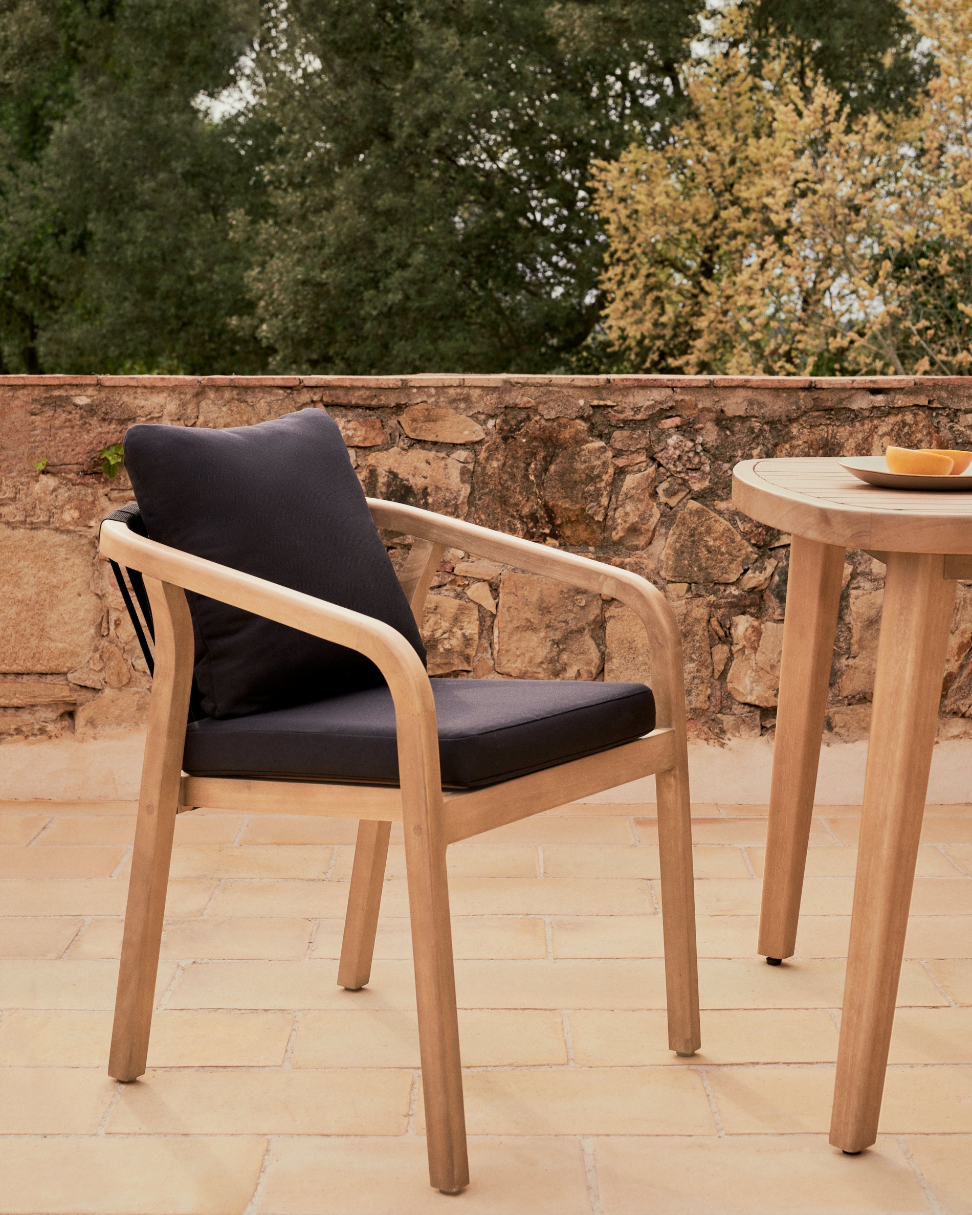 Malaret stackable chair in solid eucalyptus and black cord, FSC - Lifestyle