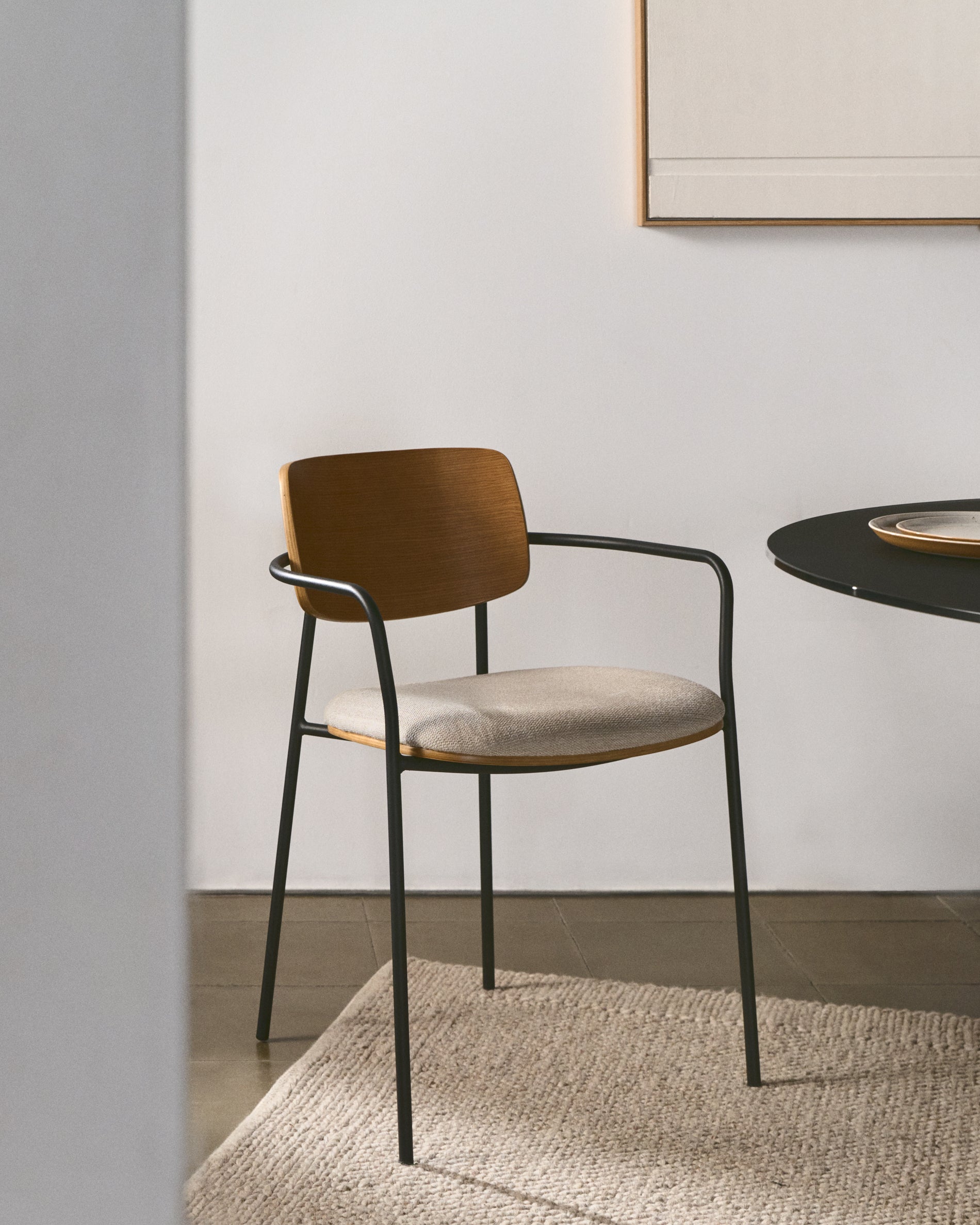 Maureen stackable chair in poplar plywood with light tone finish and black metal legs, 100% FSC. - Lifestyle