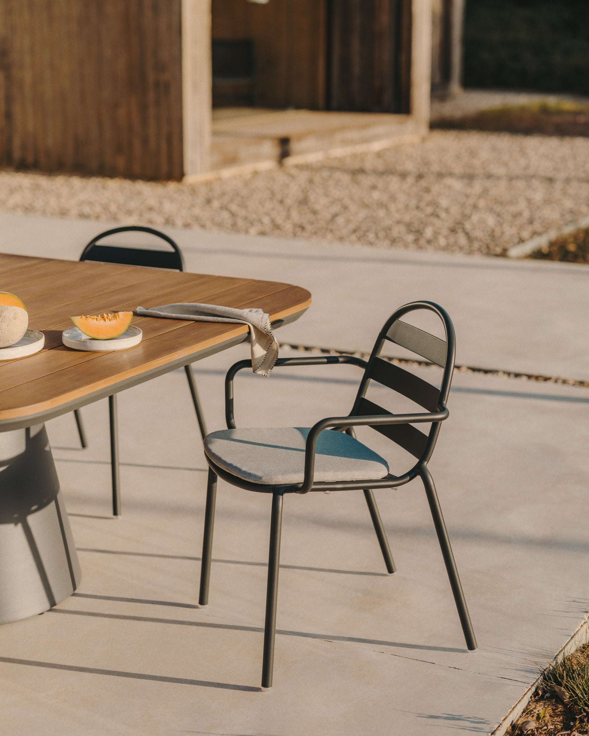 Joncols stackable outdoor aluminium chair with a powder coated grey finish - Lifestyle