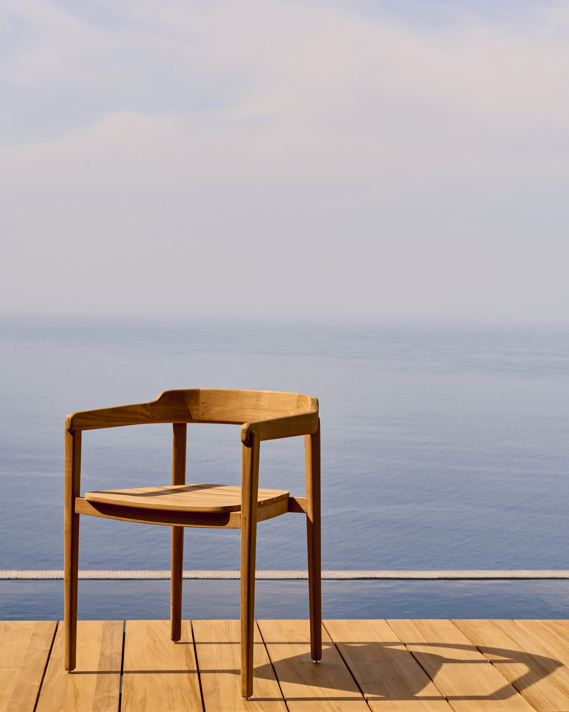 Icaro stackable solid teak wood chair in a natural finish, FSC 100% - Lifestyle
