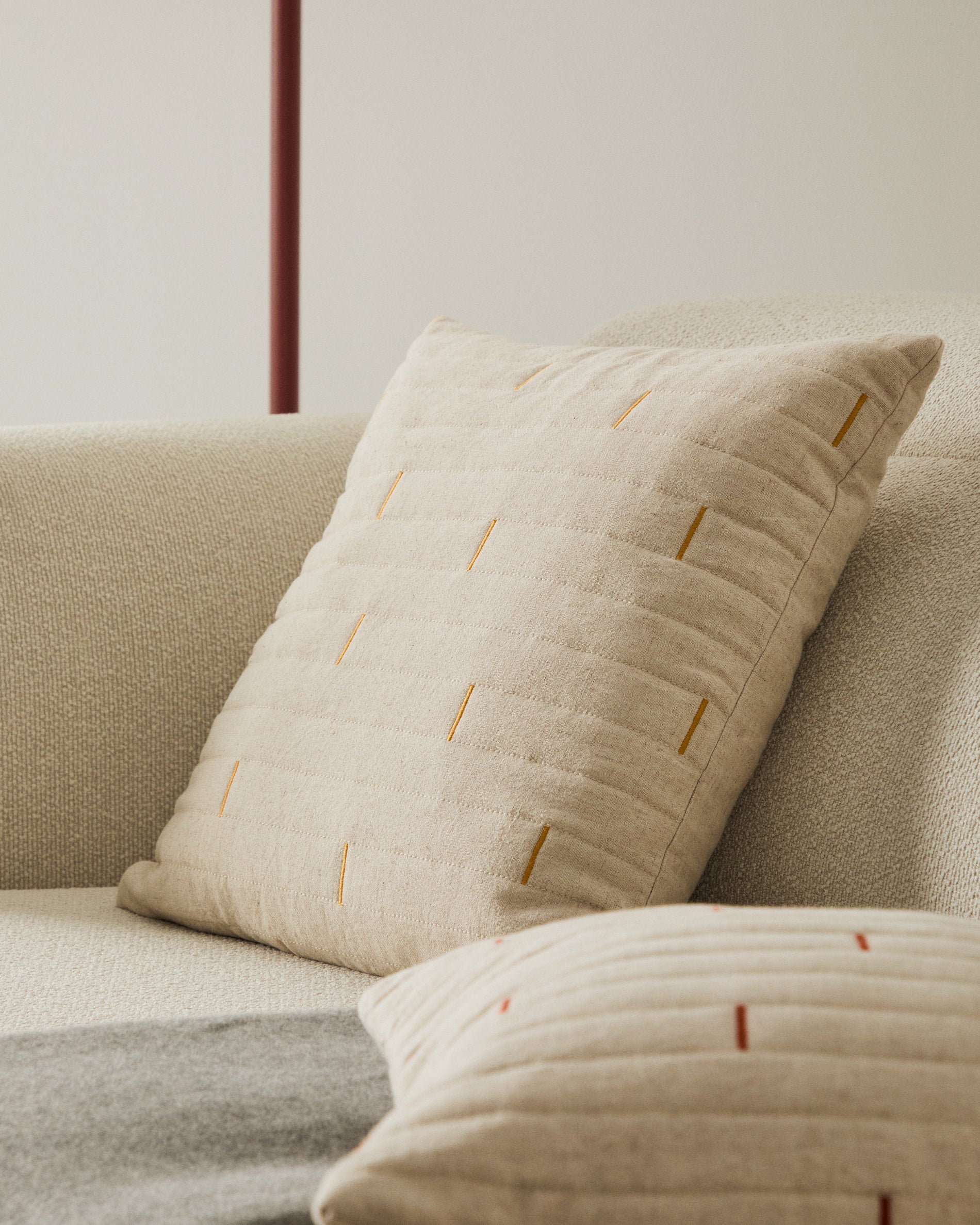 Blaina cushion cover in white linen with an orange embroidery feature, 45 x 45 cm - Lifestyle