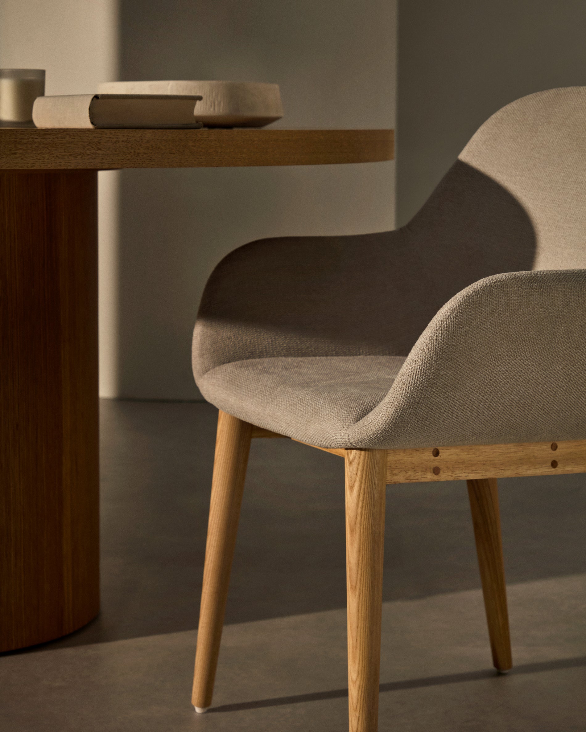 Konna chair in beige with solid ash wood legs in a natural finish - Lifestyle