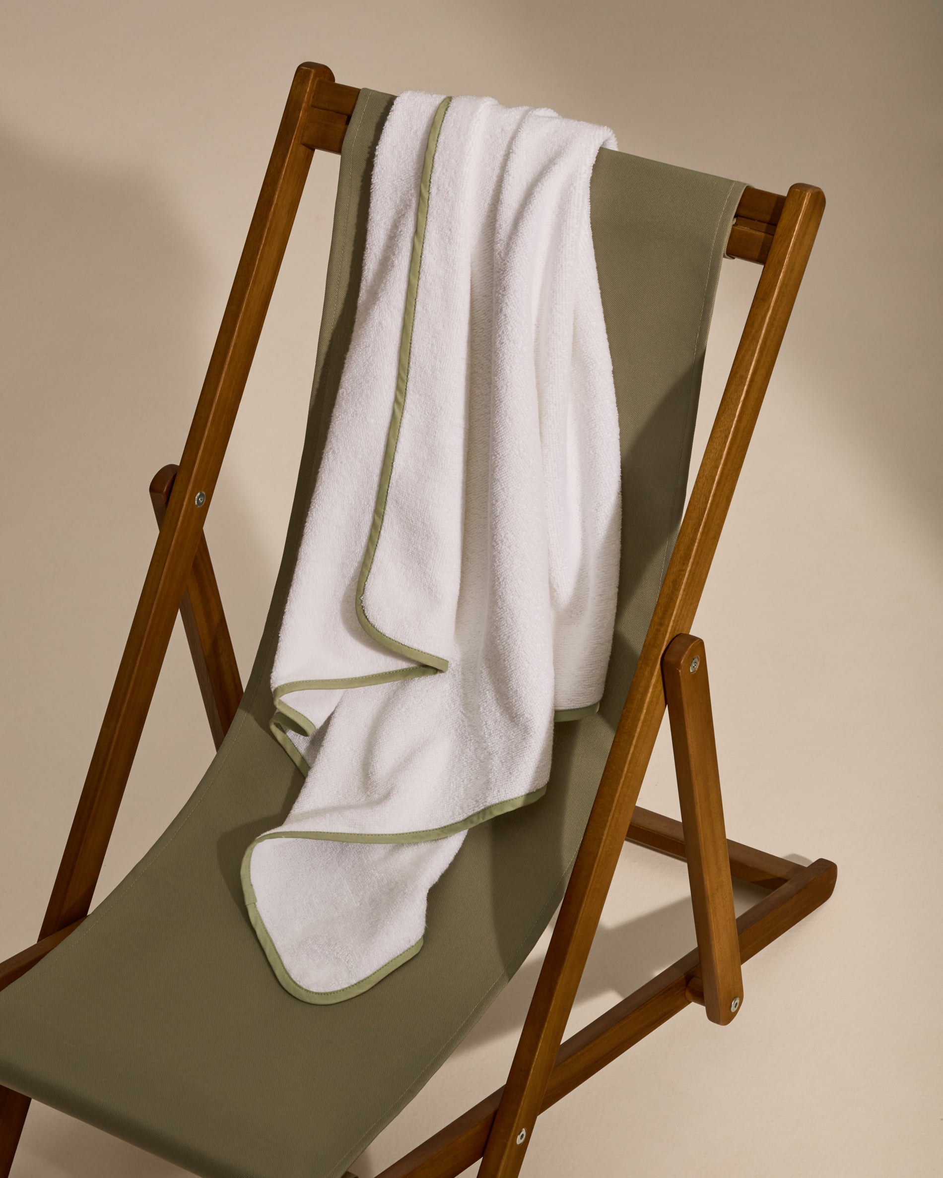 White cotton Nuni hooded towel with a green trim - Lifestyle