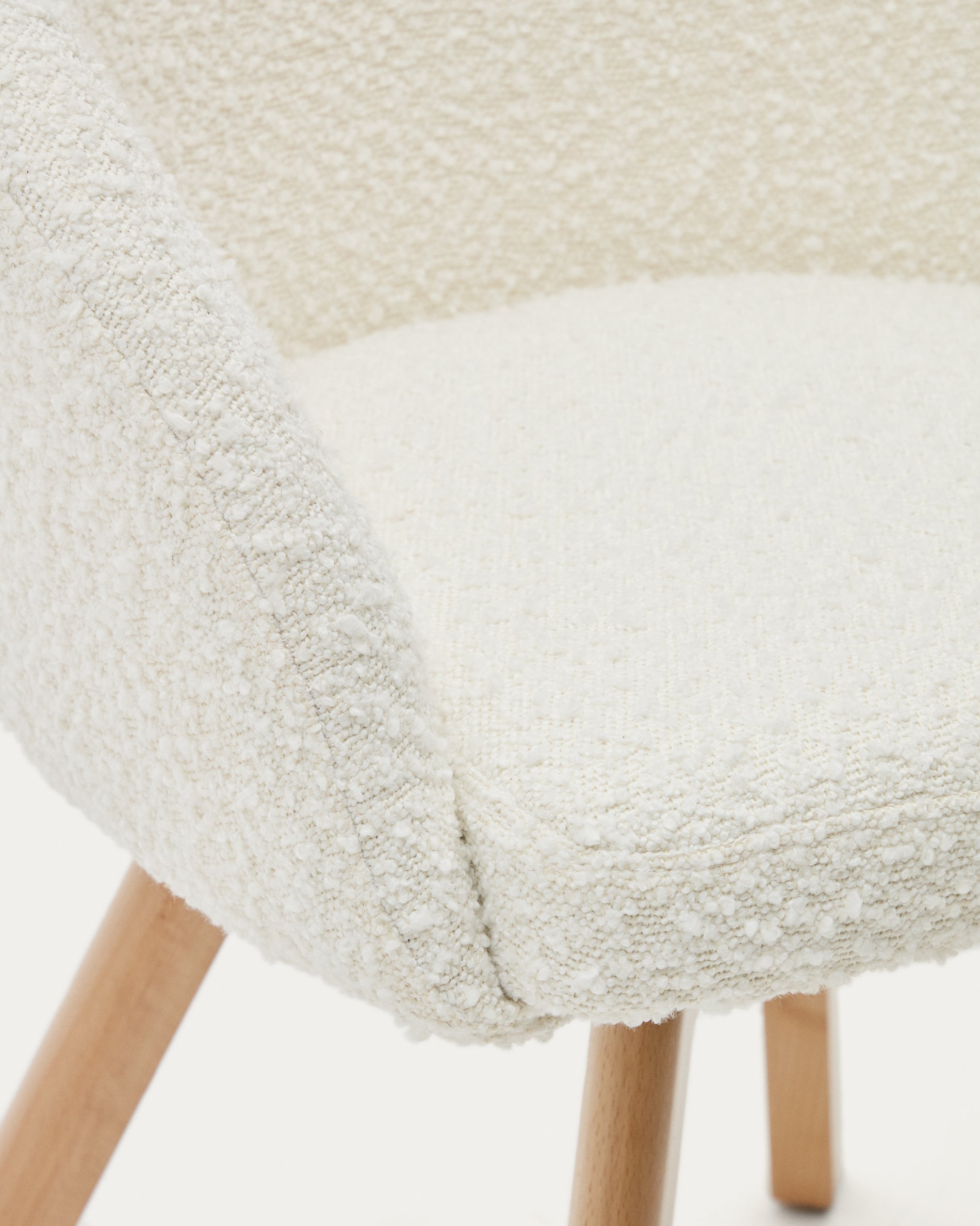 Marvin swivel chair in white bouclé with solid beech wood legs in a natural finish