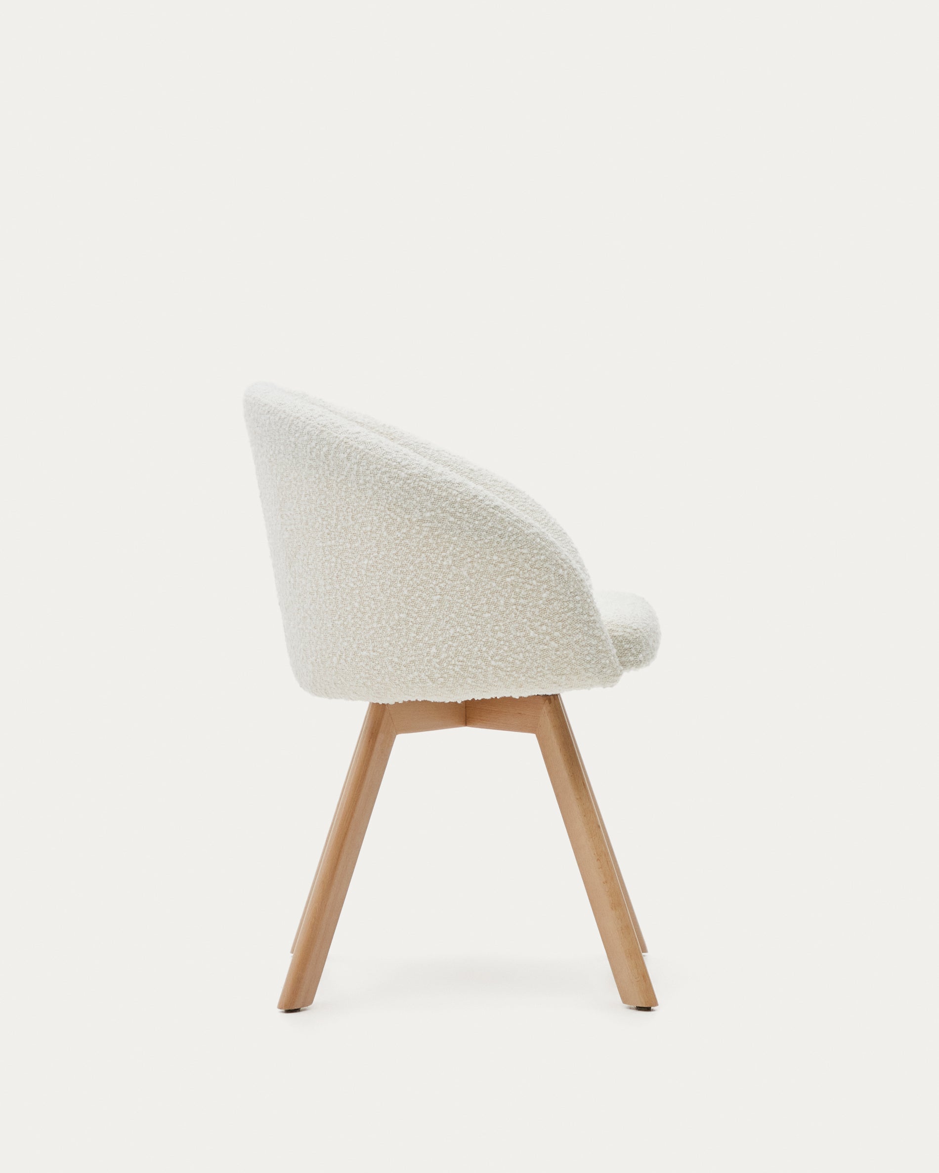 Marvin swivel chair in white bouclé with solid beech wood legs in a natural finish