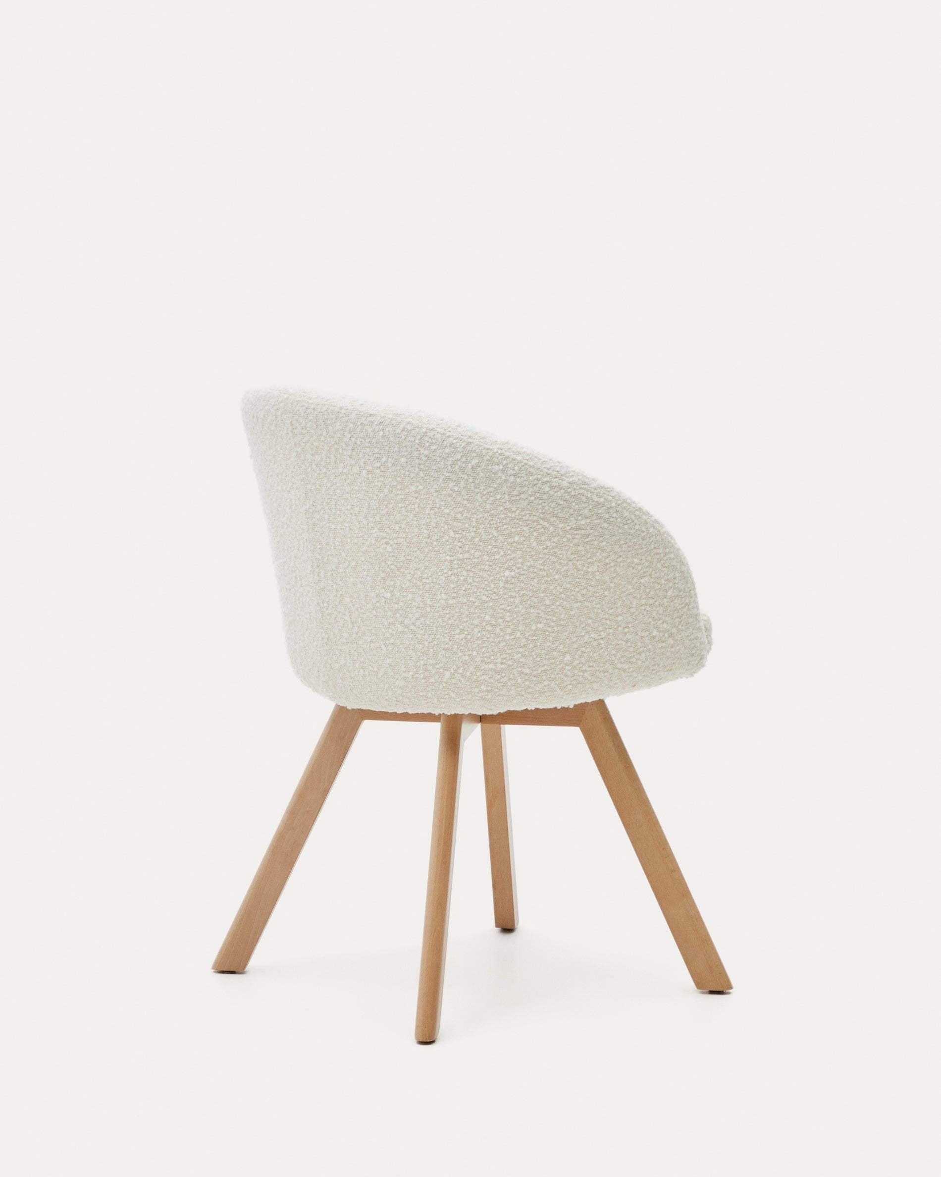 Marvin swivel chair in white bouclé with solid beech wood legs in a natural finish