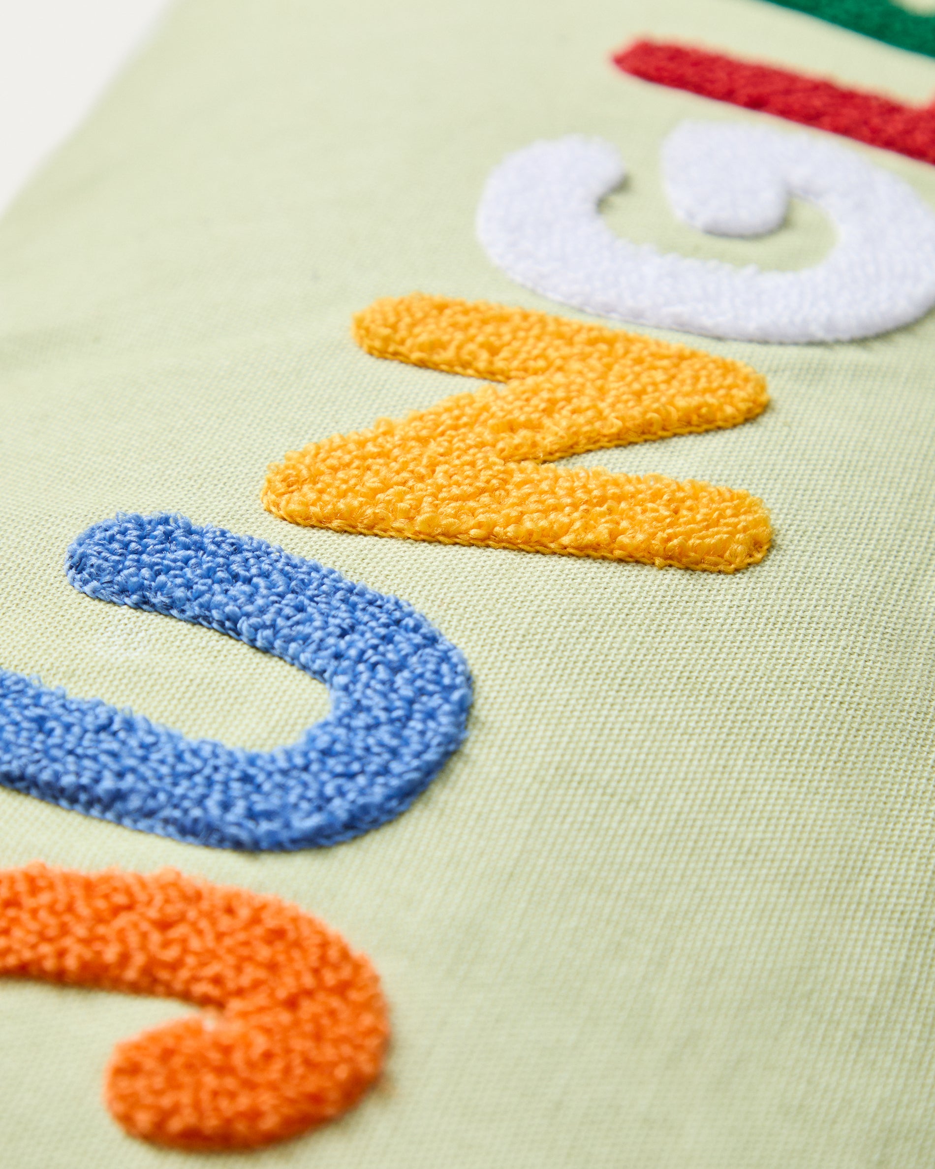 Tandani green cotton cushion cover with multicoloured embroidered lettering 30 x 50cm - Detail