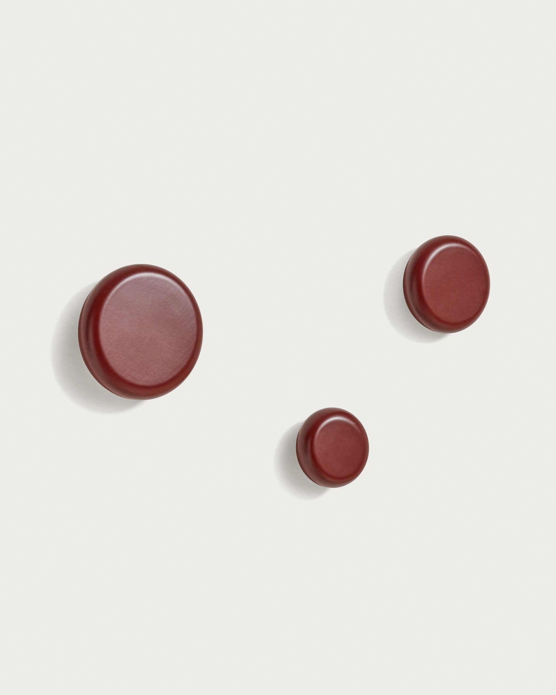 Nadue set of 3 solid beech wood wall hooks with a maroon finish - Product View